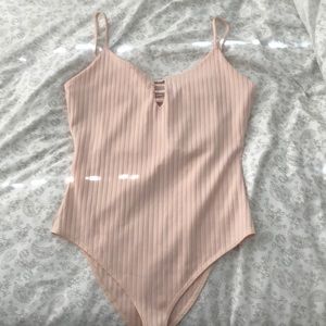 Spaghetti strap pale pink body suit from Tilly’s.